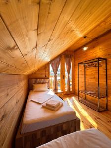 a bedroom with two beds in a wooden cabin at Seaside Cottages, BEDO HOUSE in Batumi +27 photos