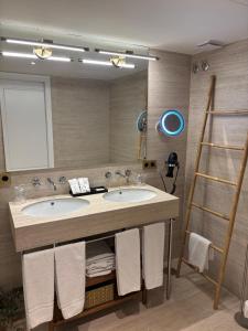 a bathroom with two sinks and a large mirror at Hotel Europa Boutique Sevilla in Seville +78 photos