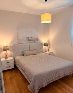a bedroom with a white bed with two night stands at Apartment Aleks in Tar +32 photos