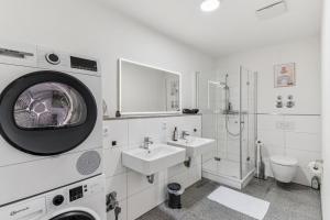 a white bathroom with a sink and a washing machine at Cozy Apartment Central Kitchen Balcony in Frechen +14 photos