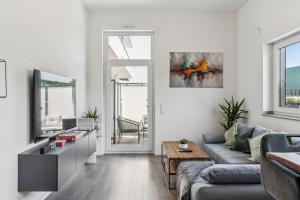 a living room with a couch and a table at Cozy Apartment Central Kitchen Balcony in Frechen