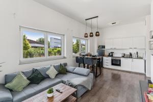 a living room with a couch and a kitchen at Cozy Apartment Central Kitchen Balcony in Frechen