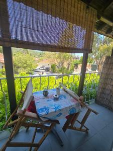 a table and chairs on a balcony with a view at Athina Studios in Chorto