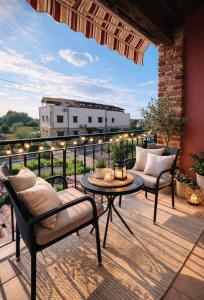 a patio with two chairs and a table on a balcony at Apartment Aleks in Tar