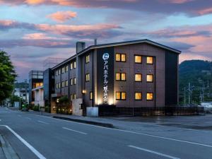 a building with a sign on the side of it at APA Hotel Karuizawa Ekimae Karuizawaso in Karuizawa