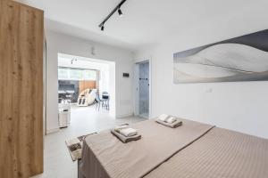 a bedroom with a large bed with two towels on it at Green Luxe Suite 2 by PikHost in Shkodër