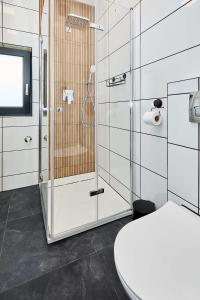 a bathroom with a glass shower and a toilet at Apartamenty w Żywcu u Astrid in Żywiec +94 photos