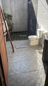 a bathroom with a toilet and a sink at Alaksa villa padang padang 6 in Bingin Beach +4 photos