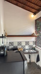 a kitchen with a stove and a counter top at Alaksa villa padang padang 6 in Bingin Beach