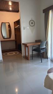 a room with a desk and a chair and a mirror at Alaksa villa padang padang 6 in Bingin Beach