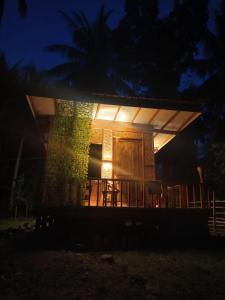 a house with a light on the front at night at A2 Coconut in Pulau Sarang