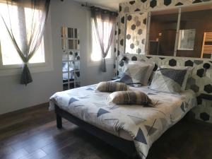 a bed with two pillows on it in a bedroom at La résinière in Salles