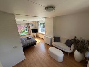 a living room with a couch and a chair at B&B Zwiep in Lochem