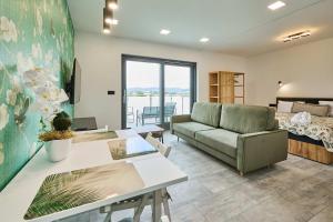 a living room with a couch and a bed at Apartamenty w Żywcu u Astrid in Żywiec