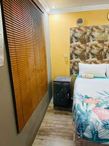 a bedroom with a bed and a stone wall at Lake boutique hotel empire in Thohoyandou