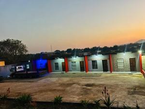 a building with orange and blue lights on it at Lake boutique hotel empire in Thohoyandou