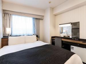 a hotel room with a bed and a desk and a television at APA Hotel Karuizawa Ekimae Karuizawaso in Karuizawa