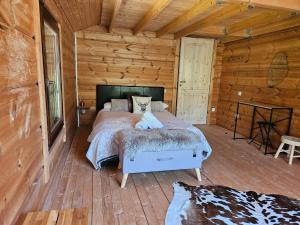 a bedroom with a bed in a log cabin at Chalet Etoile in Abondance
