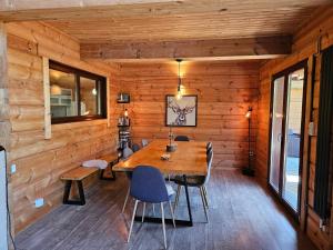a wooden room with a wooden table and chairs at Chalet Etoile in Abondance