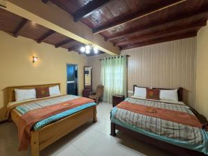 a bedroom with two beds in a room at Himawari Hills Hotel and Hostel in Nuwara Eliya +134 photos