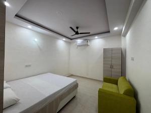 a bedroom with a bed and a ceiling fan at Yashoda Inn in Ormānjhi
