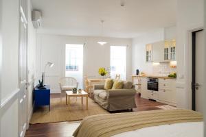 a living room with a couch and a table at Casa Do Mercado by Heart of Funchal in Funchal