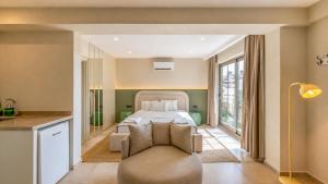 a bedroom with a bed and a couch in a room at Luz Suites in Kaş