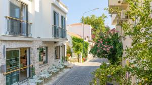 an alley in an old town with flowers at Luz Suites in Kaş