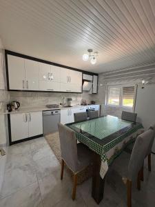 a kitchen with a table and chairs in it at HAPPY HOUSE 1 Pamukkale in Pamukkale