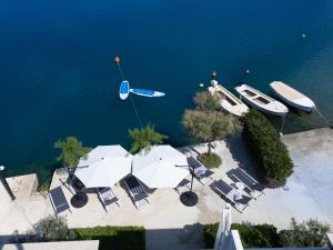 an overhead view of a table with umbrellas and boats in the water at Apartment Antun - Adriatic coast retreat in Blace +21 photos