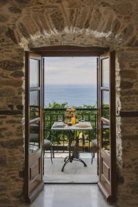 an open door to a balcony with a table with fruit on it at Tilia Resort in Mouresi
