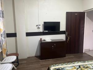a room with a bed and a tv on a cabinet at La Renada in Mawphlang +15 photos