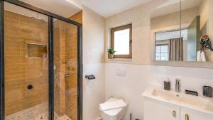 a bathroom with a shower and a toilet and a sink at Luz Suites in Kaş +11 photos