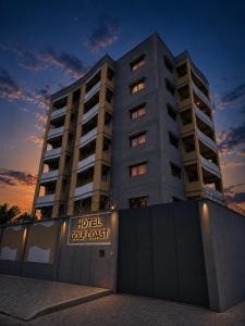 a hotel apartment building with a sign in front of it at Hotel Golf Coast in Kinshasa