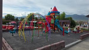 a playground with a slide and a play structure at Cottage on Issyk-Kul, Royal Beach in Chok-Tal