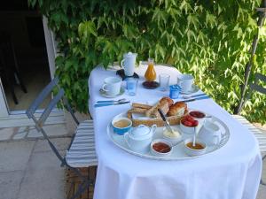 a table with a plate of food on it at Maison de Marie in Bléré