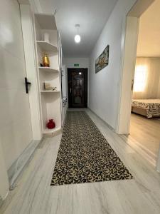 a hallway with a rug in front of a door at HAPPY HOUSE 2 Pamukkale in Pamukkale