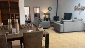 a living room with couches and a table and chairs at Ca Zoe calma y mar in Matola