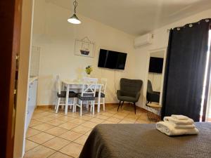 a bedroom with a table and chairs and a dining room at Casa Giulia Olbiamare in Olbia