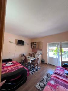 a living room with two beds and a table at Krapce - Lake View Apartments in Star Dojran