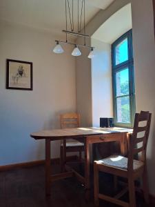 a dining room table with chairs and a window at Oben im Selketal Parterre in Harzgerode