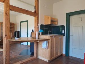 a kitchen with a wooden counter and a sink at Oben im Selketal Parterre in Harzgerode +7 photos