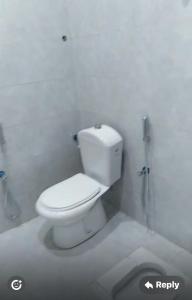 a white bathroom with a toilet and a shower at شقق النخبة The Elite department in As Sayl aş Şaghīr +16 photos