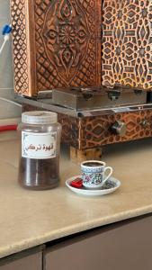 a cup of coffee sitting on a counter next to a box at شقق النخبة The Elite department in As Sayl aş Şaghīr