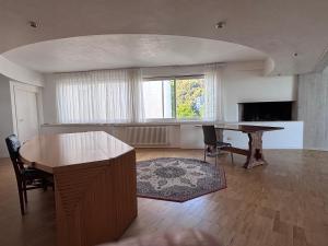 a living room with a wooden table and a desk at Nuovo Progetto A&E in Vicenza