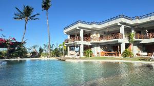 a large house with a swimming pool in front of it at Refúgio prea in Cruz