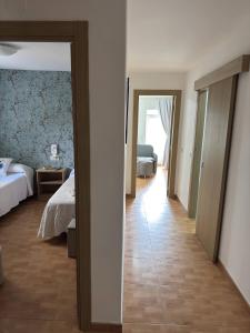 a view of a bedroom with a bed and a hallway at Apartamento Linde in Muros