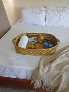 a basket filled with toys on a bed at Mbeyustays in Malindi