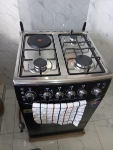 a stove top oven with a towel on it at Mbeyustays in Malindi