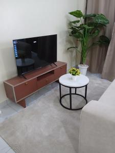 a living room with a tv and a table at Mbeyustays in Malindi